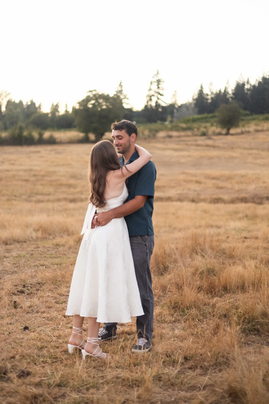 Couple embracing in the open pasture